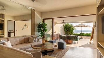 A modern living room with a sofa, coffee table, and dining area.