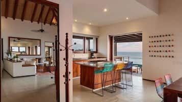 A modern kitchen featuring rustic wood finishes, bar seating, and an open-air design perfect for entertaining.