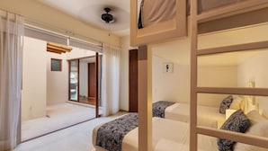 A hotel room with two beds, a ceiling fan, and a view through a window. - 3BR Beachfront Villa • Private Terrace + Pool (Zihuatanejo)