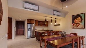 A modern kitchen with a central island, built-in cabinets, and pendant lighting.