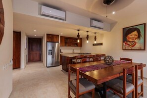 A modern kitchen with a central island, built-in cabinets, and pendant lighting. - Zihua 3BR Villa • Oceanfront + Sleeps 6 + Family (Zihuatanejo)