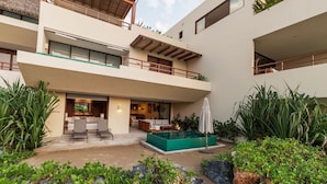 A modern multi-story building with a rooftop terrace, a swimming pool, and a landscaped garden area. - Zihua 3BR Villa • Oceanfront + Sleeps 6 + Family (Zihuatanejo)