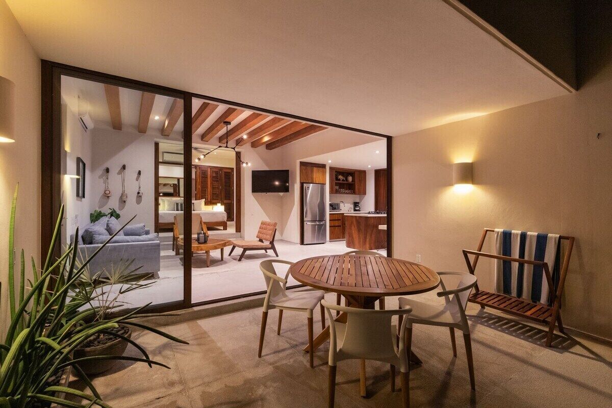 A modern interior with a dining area, kitchen, and living space.
