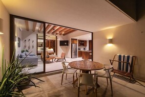 A modern interior with a dining area, kitchen, and living space. - 1BR Romantic Villa • Ocean View in Playa Blanca (Zihuatanejo)