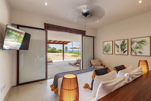 A modern room with a bed, a television, and a view of the outdoors.