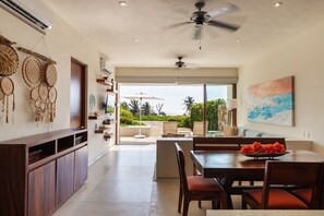A spacious kitchen with a dining area, a ceiling fan, and a view to the outdoors.