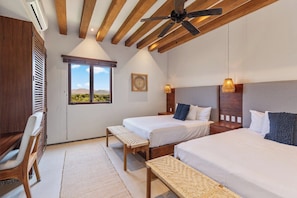 A bedroom with two beds, a ceiling fan, a window with a view, and a desk with a chair. - 4BR Villa Playa Blanca – Infinity Views & Comfort (Zihuatanejo)