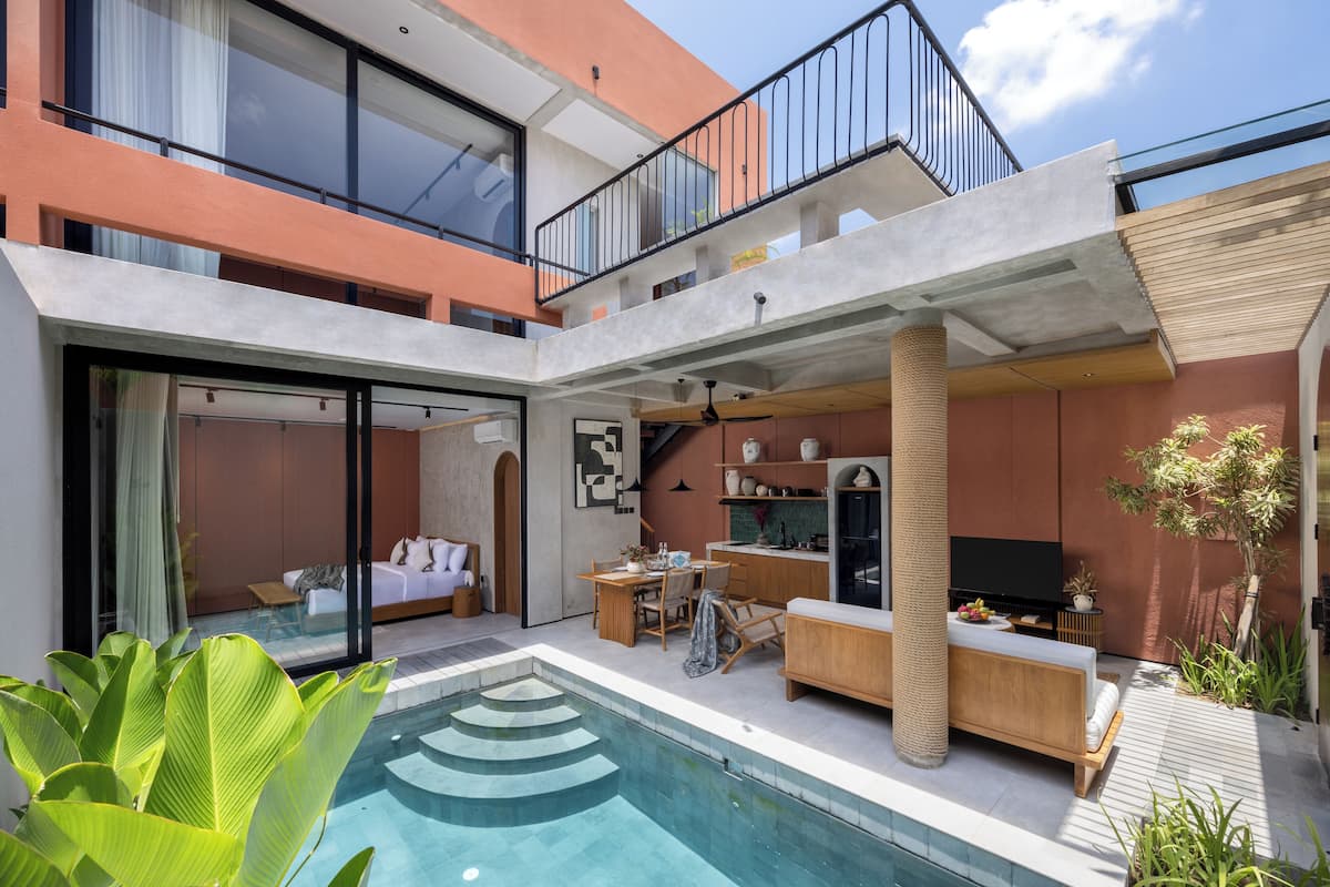 A modern two-story house with a swimming pool, outdoor seating area, and a flat-screen TV.