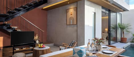 Deluxe Villa, Pool View | Living area | Flat-screen TV