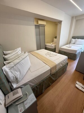 Deluxe Quadruple Room | Egyptian cotton sheets, premium bedding, in-room safe - Ambiance Downtown Hotel (Cairo)