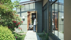 A modern building with a wooden door and a glass entrance. - Ichi to Koji (Gojome)