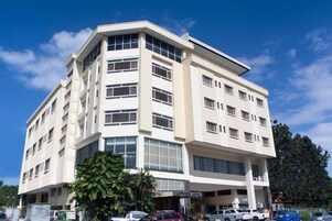 A multi-story hotel with a modern design, featuring large windows and a flat roof.