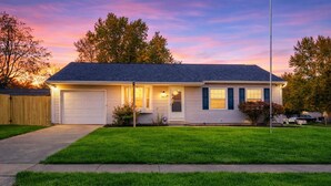 A single-story house with a garage, a front porch, and a well-maintained lawn.