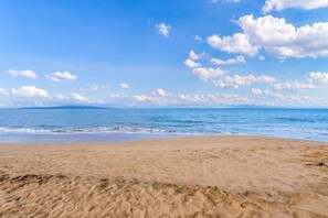 A beach with a clear sky and calm sea.