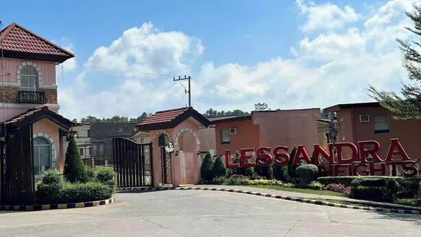 A gated entrance to a residential complex named "Lessandra Heights" with a clear sky and a few clouds. - American Standard/2Bedroom House (Cagayan de Oro)