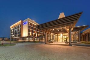 A modern hotel with a prominent MYZE sign, a covered entrance, and a well-lit facade. - Myze Hotel Sumenep (Sumenep)