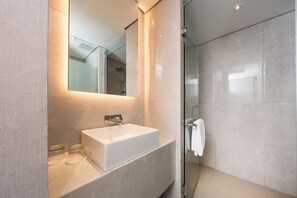 Separate tub and shower, hair dryer, slippers, towels - Myze Hotel Sumenep (Sumenep)