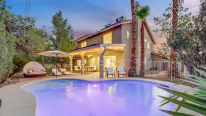 A house with a swimming pool, outdoor seating, and a covered patio area. - The Blue Lagoon: Where Space, Style and Comfort collide! (Las Vegas)