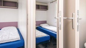 A dormitory room with two beds, each with a blue mattress and white bedding. - 2 Person Holiday Park Home in Jelling (Jelling)
