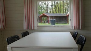 A room with a white table and six black chairs. - 2 Person Holiday Park Home in Jelling (Jelling)