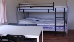 A bunk bed room with a table and chairs. - 2 Person Holiday Park Home in Jelling (Jelling)