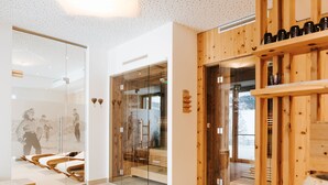 A modern interior with glass walls, wooden accents, and a seating area with benches.