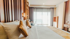 A hotel room with a large bed, a desk, and a chair. - De Balen Soultan Hotel (Jonggat)