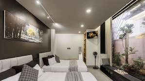 A modern bedroom with a large bed, a TV, and a view of the outdoors. - The K'rin Villa (Xuan Huong - Da Lat)