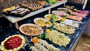 A buffet with various dishes including salads, meats, and cheeses. - Aven Hotel (Istanbul)