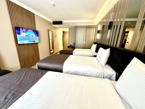 A hotel room with two beds, a TV mounted on the wall, and a wooden panel design on the wall. - Aven Hotel (Istanbul)