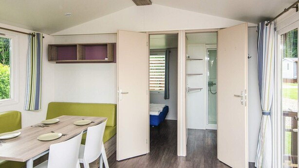 A compact, modern room with a dining area, a small bed, and a shower. - 4 Person Holiday Park Home in Jelling (Jelling)