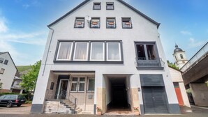 A modern two-story building with a flat roof, large windows, and a balcony. - Cheerful Holiday Home in Kinheim With Mountain Views (Kinheim)