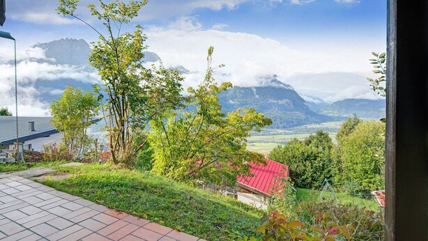 A view from a window overlooking a mountainous landscape with a red-roofed building in the foreground. - Chalet in Iselsberg-stronach Near Ski-lift (Iselsberg-Stronach)