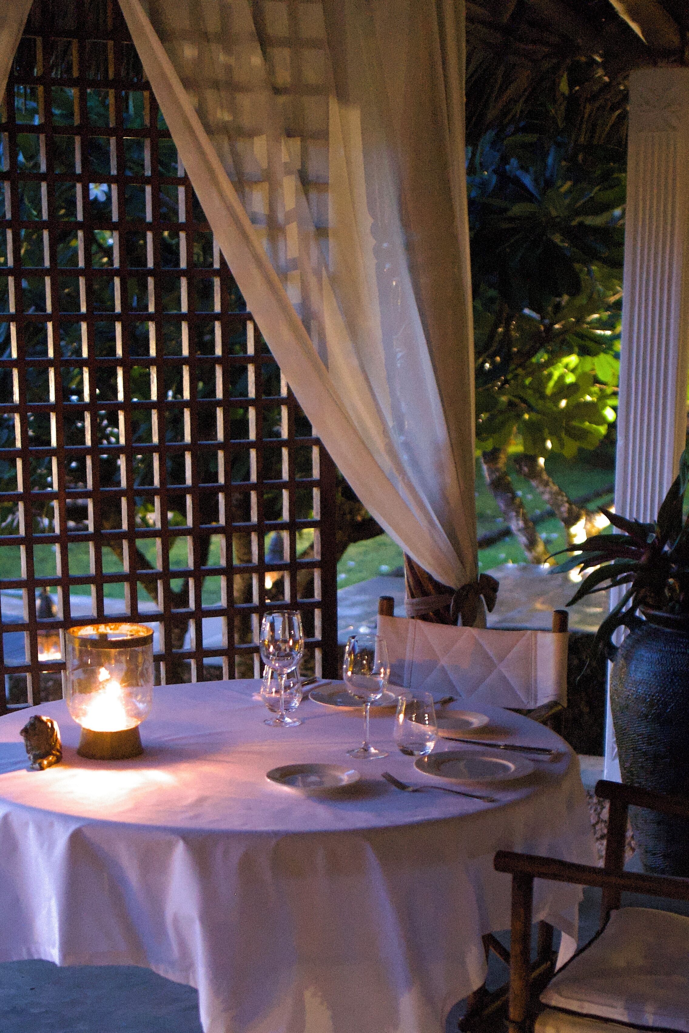 A table set for dining with candles, glasses, and plates.