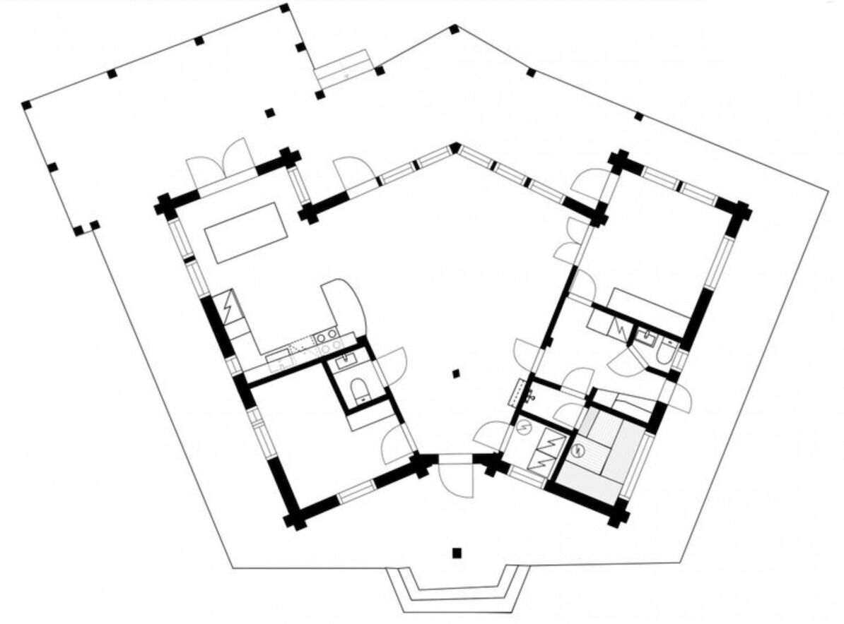 Un plan d’étage d’un hôtel comprenant plusieurs chambres, un hall d’entrée central et un espace repas.