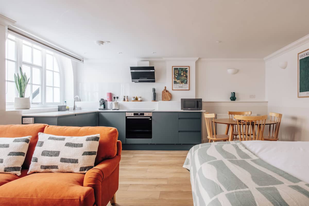 A modern apartment with a kitchen, dining area, and living space.