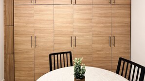 A dining area with a round table, two chairs, and a potted plant. - Nikitara Nook-Close to Metro and Train (Athina)