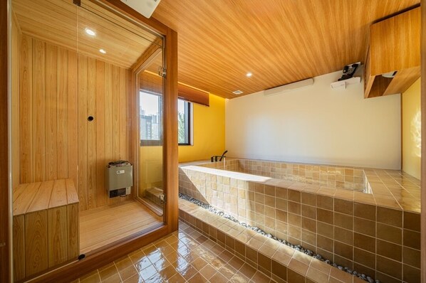 A modern bathroom with a wooden vanity, a bathtub, and a shower area. - Stay Passport Fukuoka Ryokan Daejeon Yuseong (Daejeon)