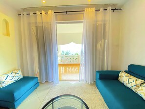 Deluxe Apartment, Partial Ocean View | Living area | Flat-screen TV - Mfalme Beachfront Apartments (Mombasa)