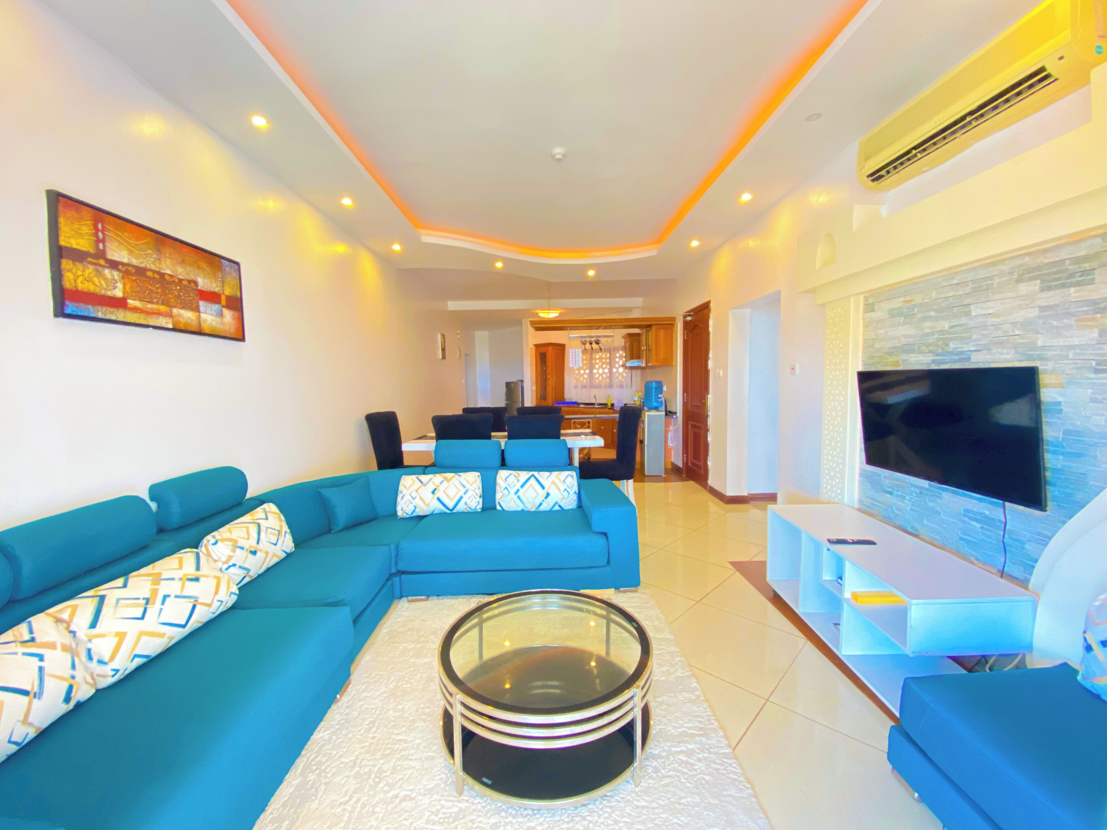 Deluxe Apartment, Partial Ocean View | Living area | Flat-screen TV