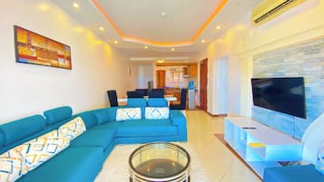 Deluxe Apartment, Partial Ocean View | Living area | Flat-screen TV