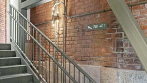 A staircase with metal railings and a brick wall. A sign with the number "201-411" is visible. - Relaxing unit near Louisville Medical Complex! (Louisville)