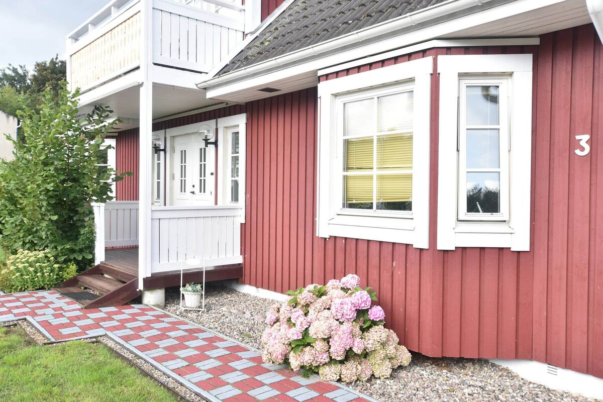A red building with a white porch and a number '3' on the side.