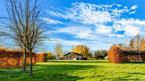A house with a lawn and trees in the background. - Tranquil Holiday Home in Lage Zwaluwe With Terrace (Lage Zwaluwe)