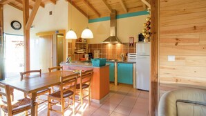 A kitchen with wooden beams, a dining table with chairs, a refrigerator, and a sink. - Spacious Holiday Home on Estate Near Covas (Tábua)