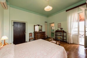 A room with a bed, dresser, mirror, and a door. - Air-conditioned Flat With Pool and Wellness Area (Citta della Pieve)