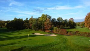 A golf course with a clear sky, trees, and a well-maintained green. - Lovely Farmhouse in Wijlre With Forest Nearby (Wijlre)
