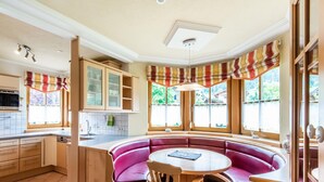 A kitchen with a built-in seating area, a dining table, and a window with curtains. - Quietly-located Apartment Near the Center of Radstadt (Radstadt)