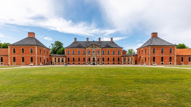 A large, symmetrical brick building with a central courtyard, featuring a symmetrical facade with evenly spaced windows and a central entrance. - Attractive Apartment in Klutz Near the Sea (Klütz)