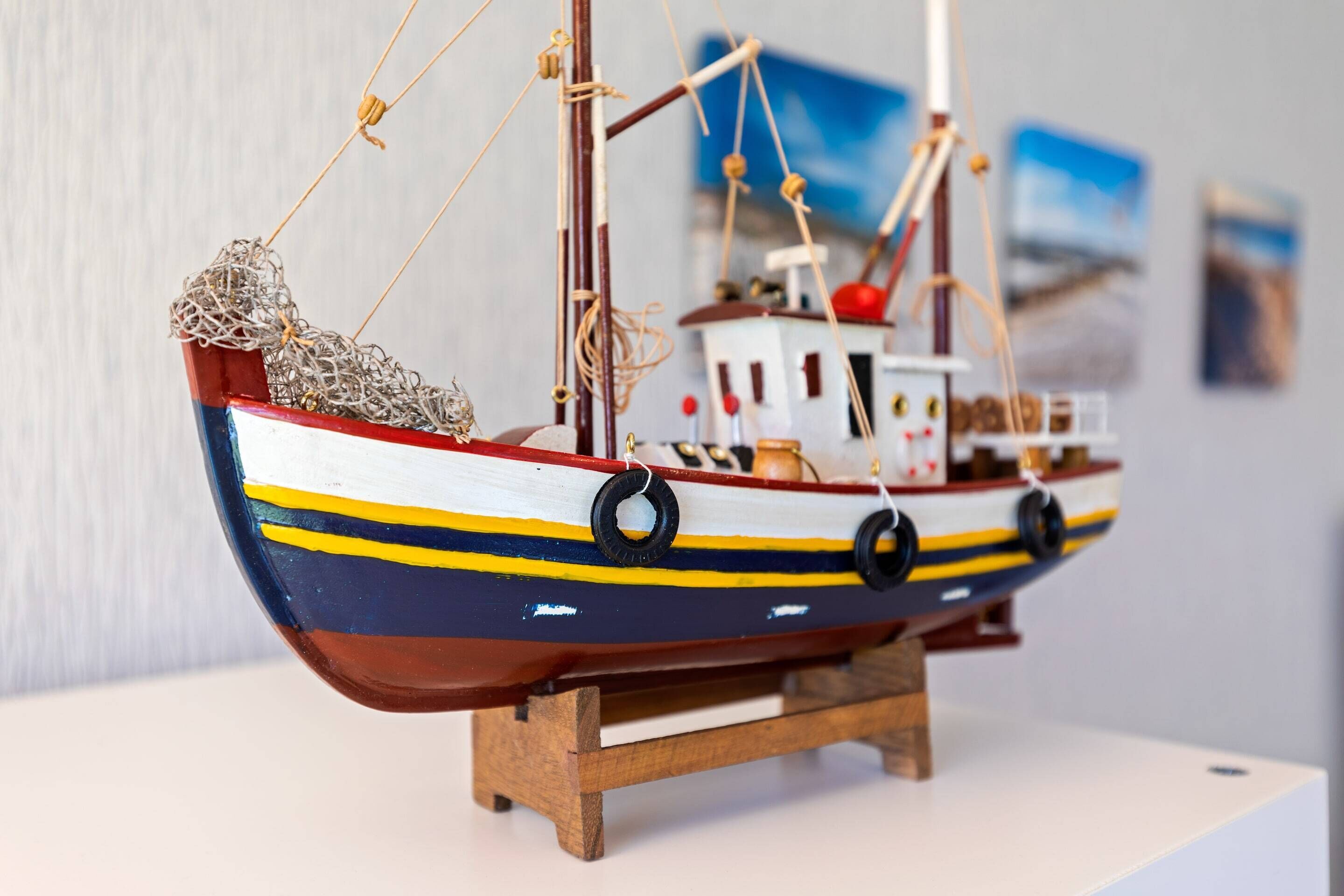 A model ship on a wooden stand.